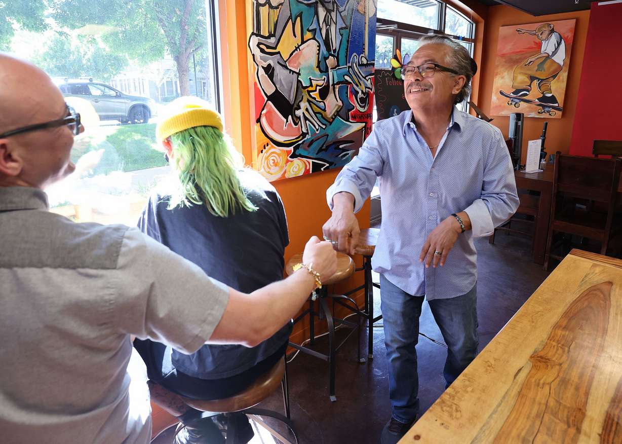 David Galvan, owner of Mestizo Coffeehouse, greets customer Bryce Draper in Salt Lake City on June 23. Galvan is worried his business will be impacted by a potential expansion of I-15 in the area.