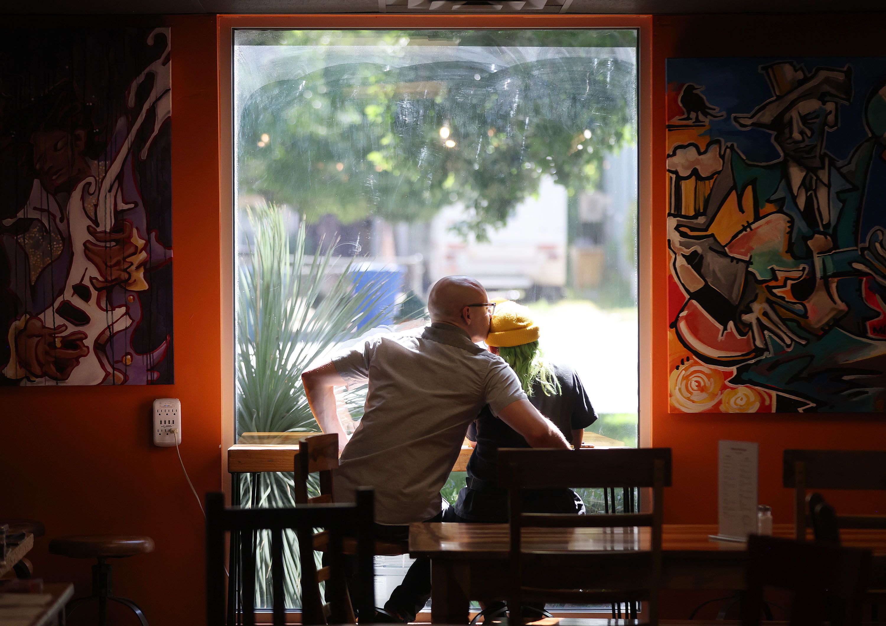 Bryce Draper and Noel Littlefield sit in Mestizo Coffeehouse in Salt Lake City on June 23. The business could be impacted by a potential expansion of I-15 in the area.