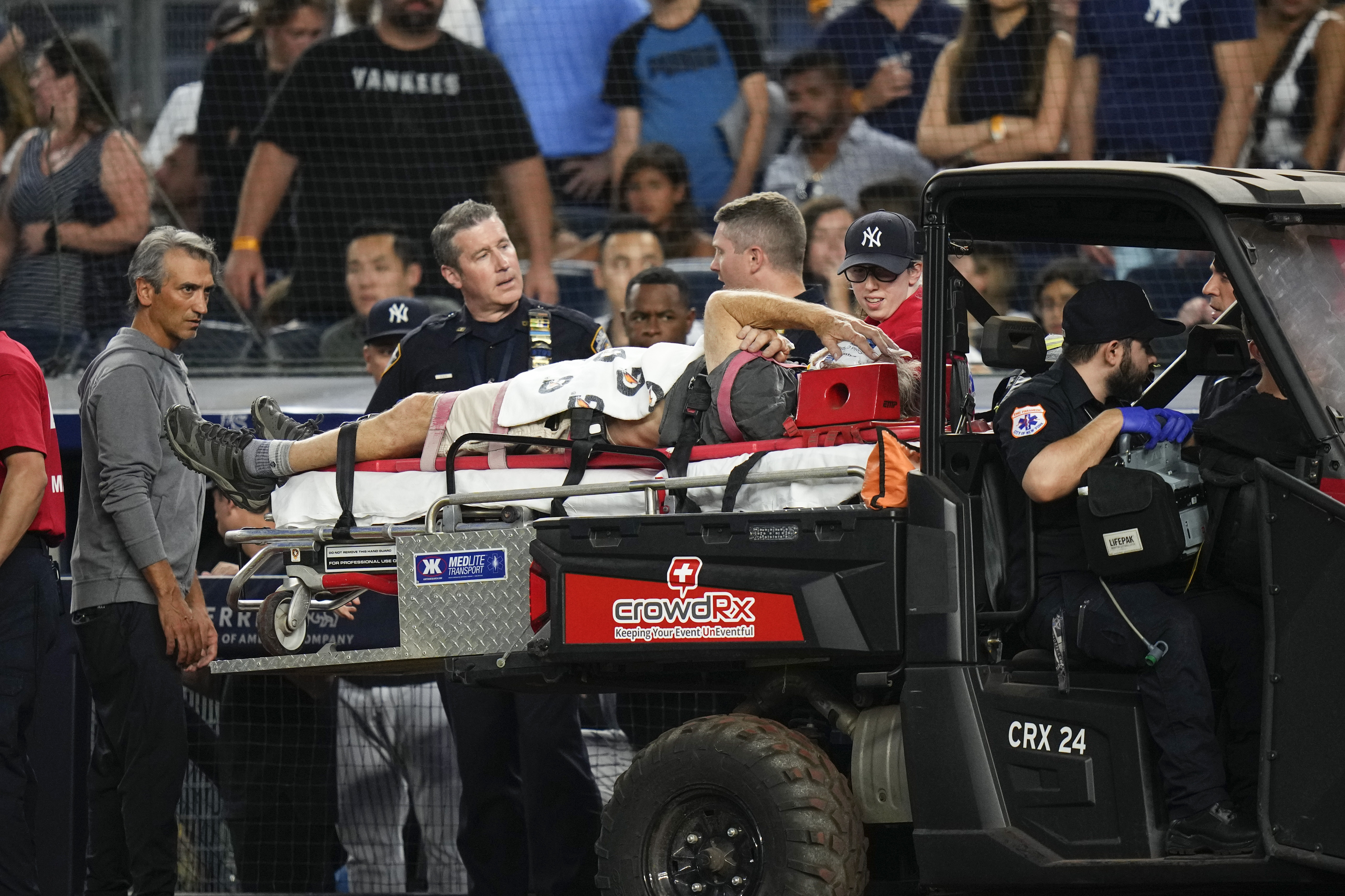 A camera operator who was injured on a throwing error by Baltimore Orioles' Gunnar Henderson has ben placed on a cart during the fifth inning of the Orioles' baseball game against the New York Yankees on Wednesday, July 5, 2023, in New York. 