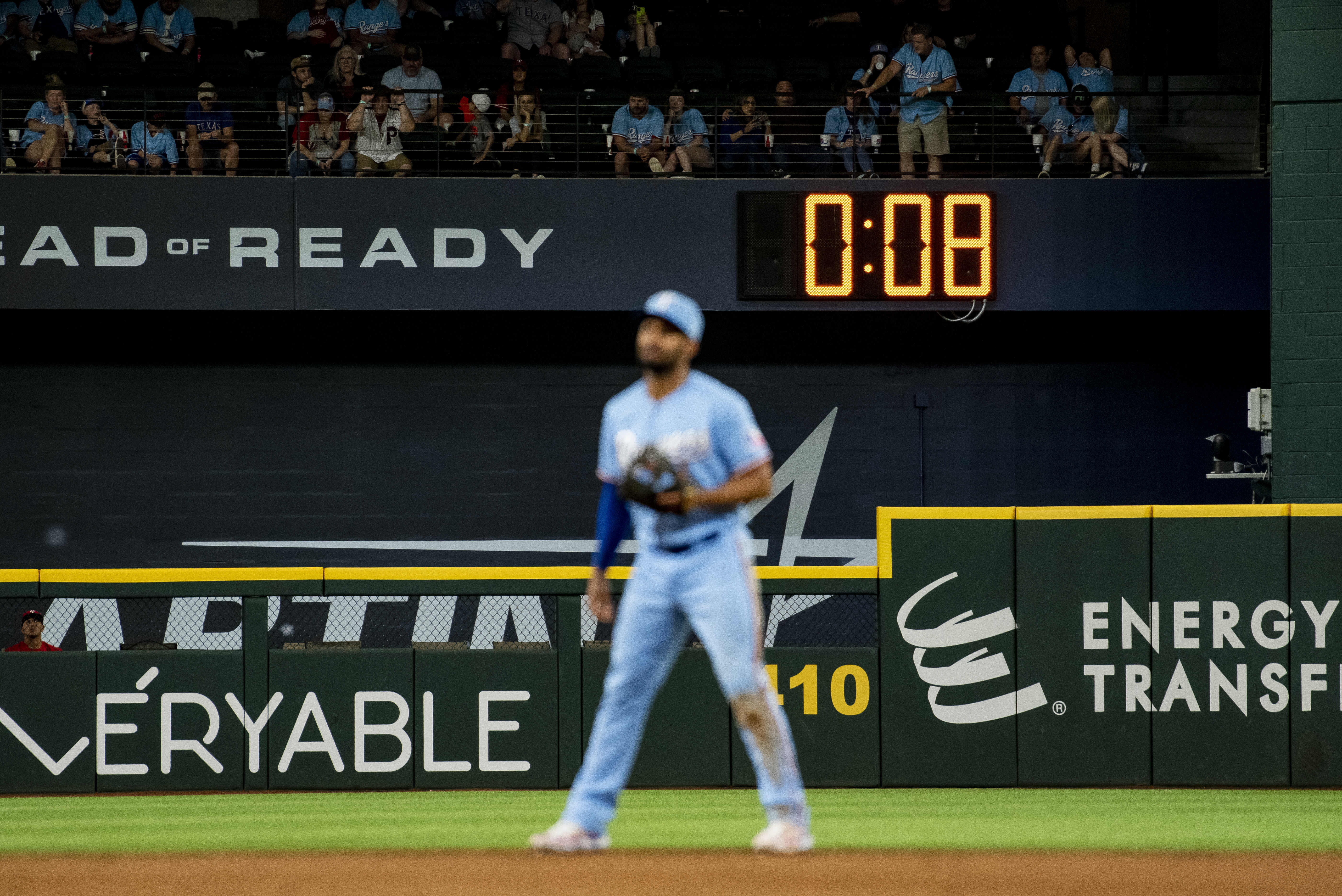 FILE - The pitch clock ticks down in the top of the ninth in a baseball game between the Texas Rangers and Philadelphia Phillies in Arlington, Texas, Sunday, April 2, 2023. Major League Baseball's pitch clock has made games go faster, but players and coaches believe it also is leading to better fielding. The pitch clock, an idea meant to make it easier for fans to stay focused on the field — may be keeping fielders locked in, too. 