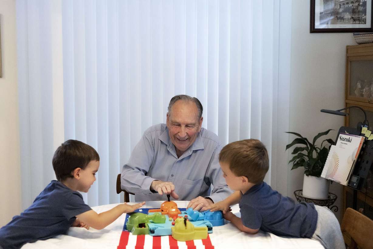 Ren Willie plays with his grandsons, Oliver and Tate, at his Murray home on Wednesday. A year ago, Willie was diagnosed with Alzheimer’s dementia, a progressive neurodegenerative disease that destroys memory and other mental functions over time.