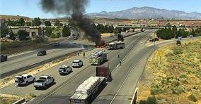 UDOT webcam shows black smoke rising from a sanitation truck Wednesday on I-15. The driver of a truck hauling construction waste was praised by firefighters for his maneuvers after his truck caught fire near the St. George Boulevard exit.