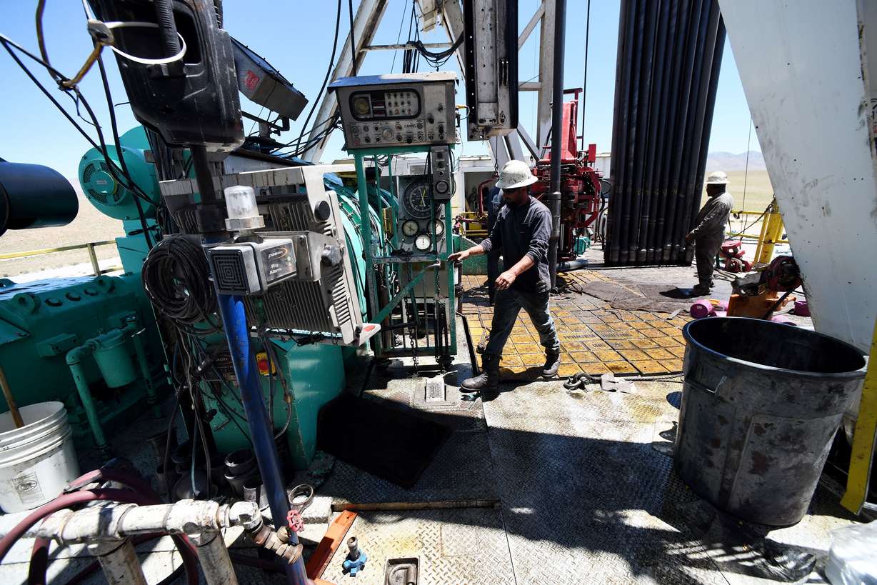 Crew members work on a drilling rig at the FORGE geothermal demonstration sight near Milford on Thursday. Media were given a tour of the facility.