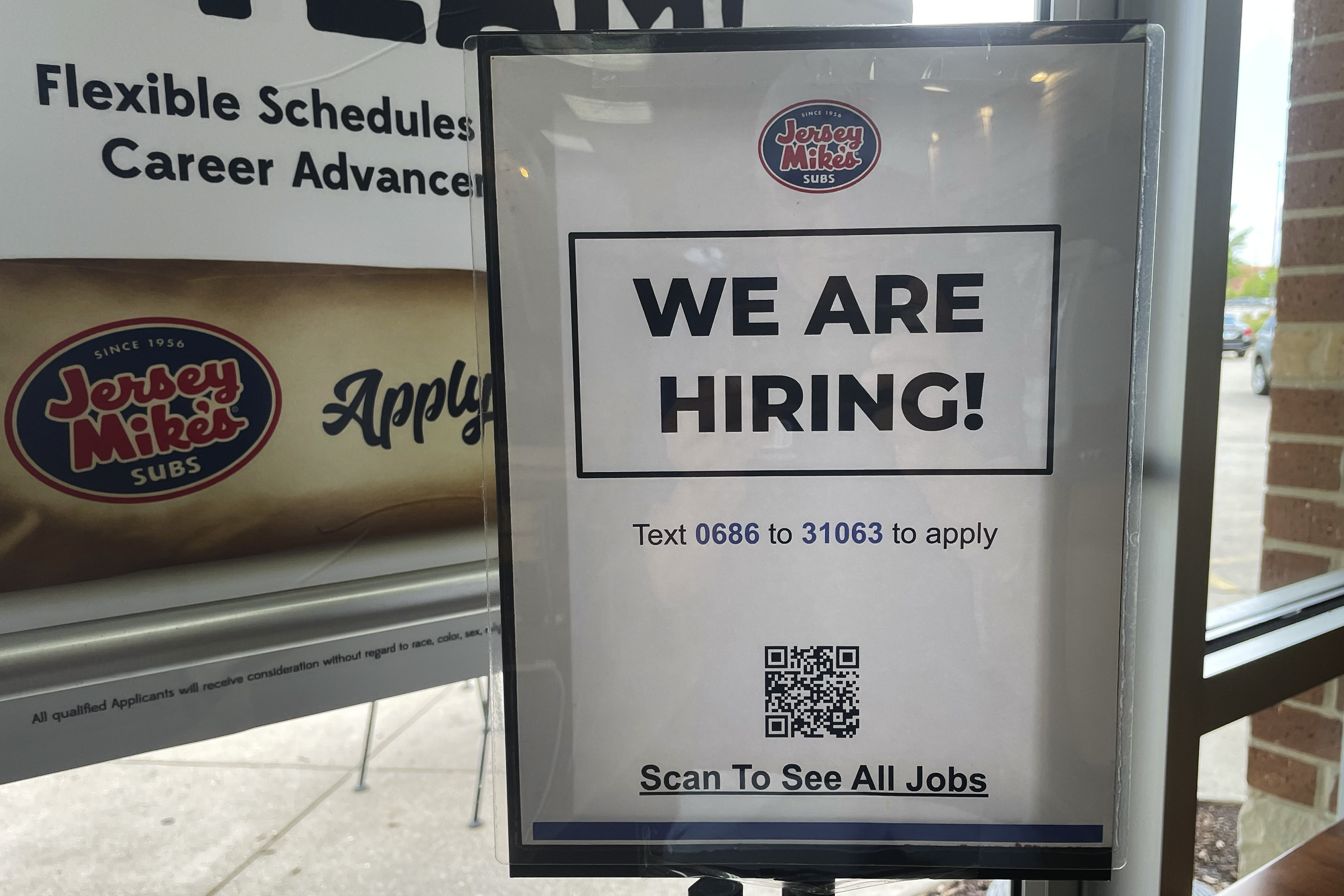A hiring sign is displayed at a restaurant in Mount Prospect, Ill., Thursday. On Friday, the U.S. government said America's employers delivered another month of solid hiring in June, adding 209,000 jobs.