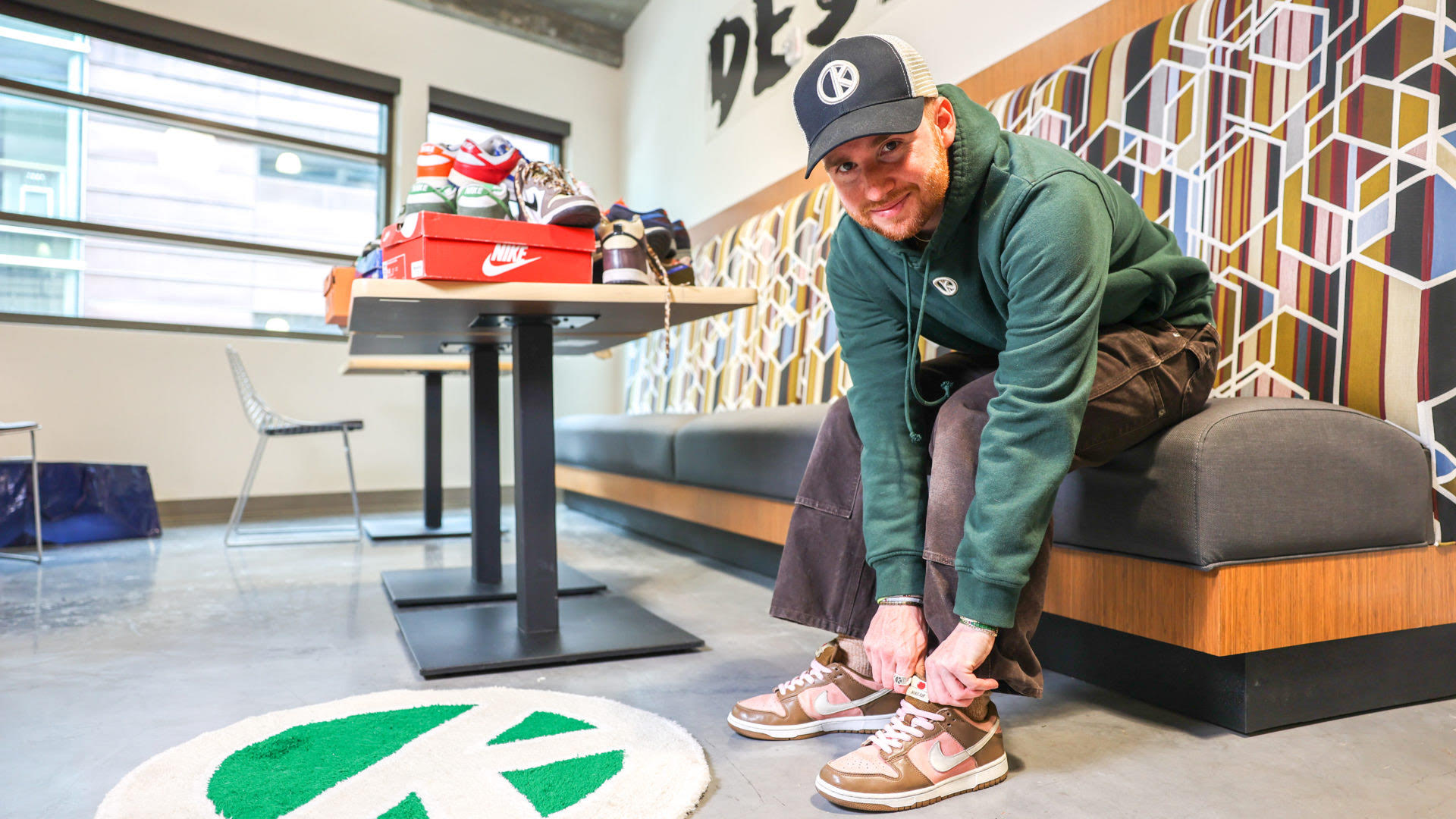 Outkits founder and owner Chase Stoner poses with a pair of sneakers. Born in 2020, Outkits is a popular online platform — its Instagram page has garnered over 24,000 followers — selling vintage sneakers, clothing and accessories. 