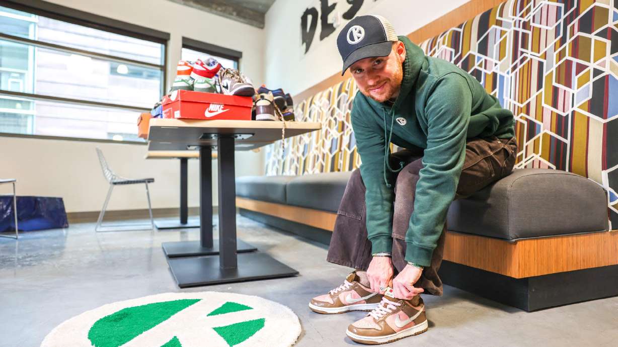 Outkits founder and owner Chase Stoner poses with a pair of sneakers. Born in 2020, Outkits is a popular online platform — its Instagram page has garnered over 24,000 followers — selling vintage sneakers, clothing and accessories.