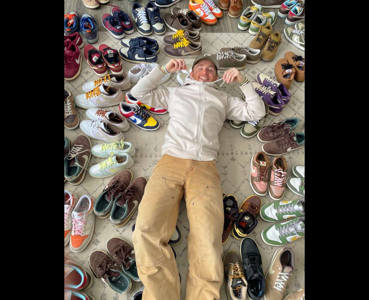 Outkits founder and owner Chase Stoner poses with his shoe collection. Born in 2020, Outkits is a popular online platform — its Instagram page has garnered over 24,000 followers — selling vintage sneakers, clothing and accessories.