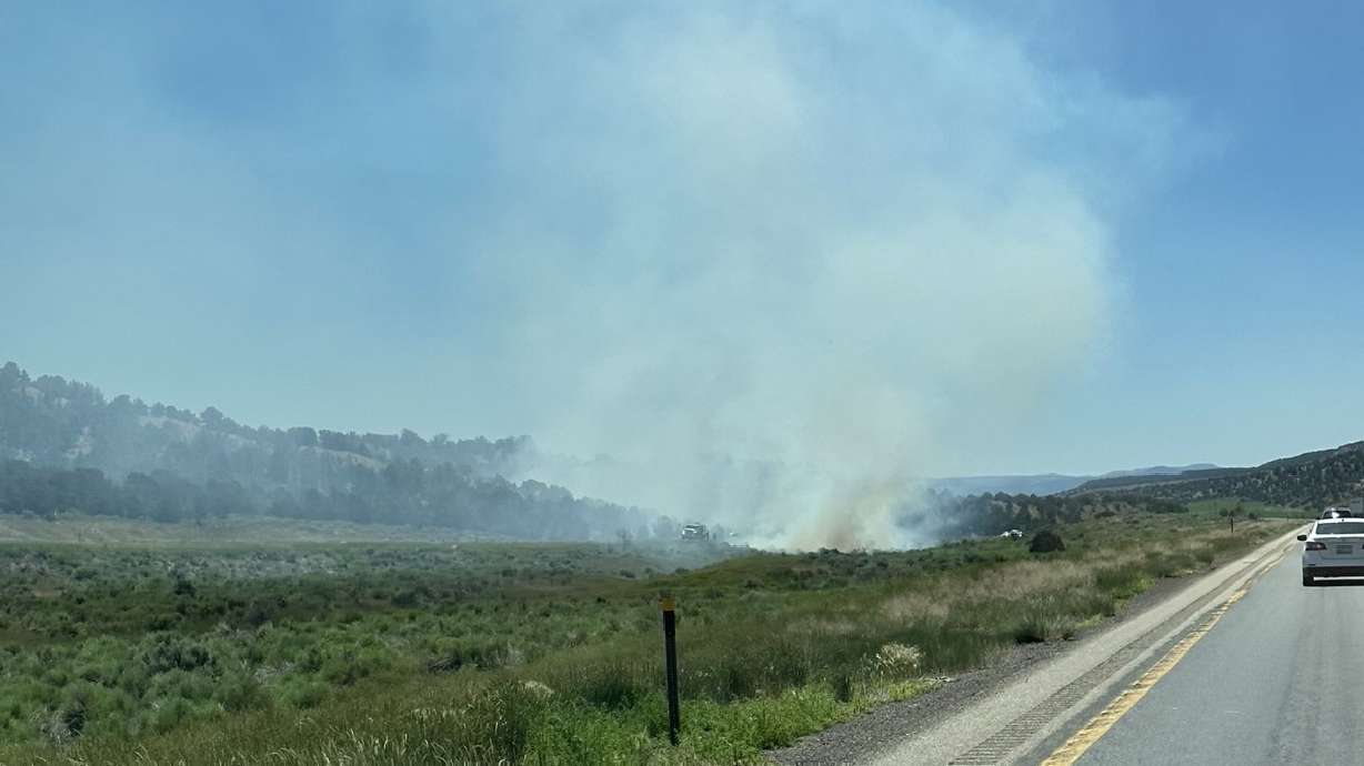 A wildfire burns near I-15 in Beaver County Friday afternoon.