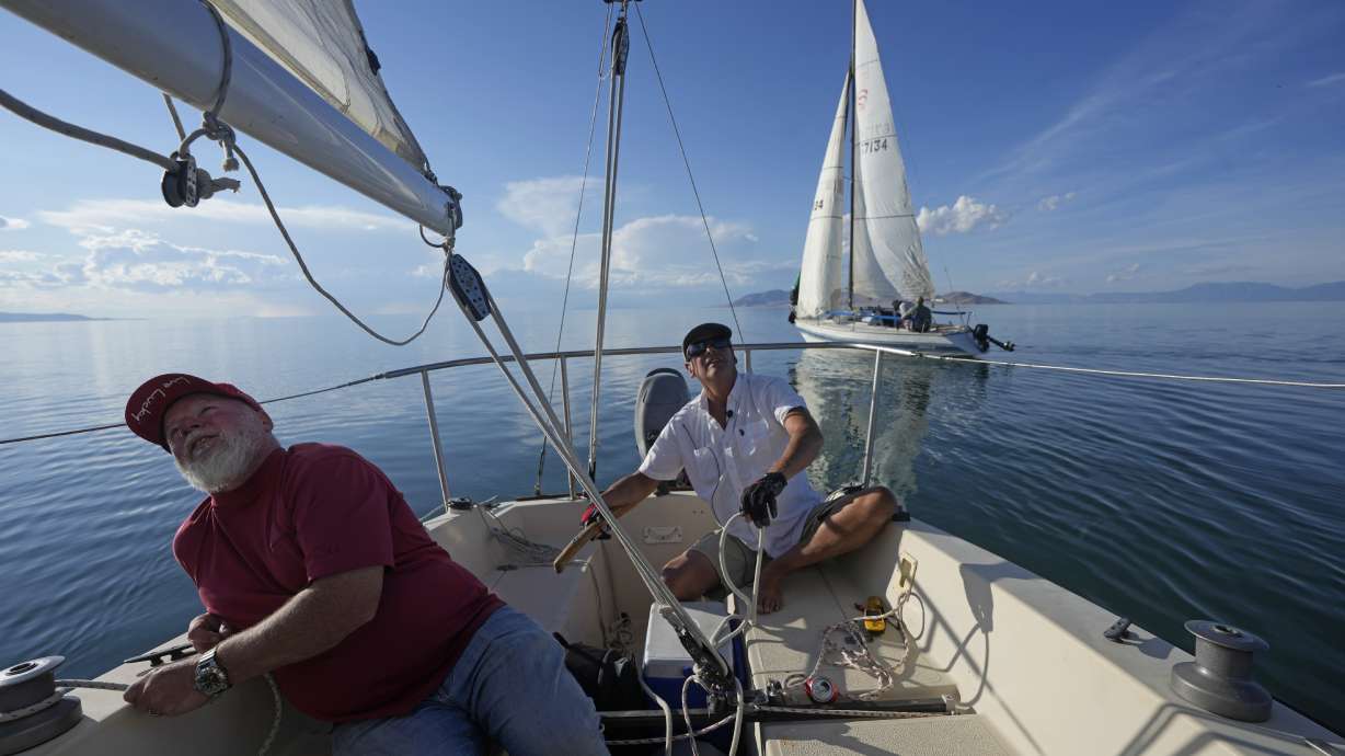 Bob Derby, right, and Randy Atkin, left, adjust sails to turn their boat through the Great Salt Lake on June 14, near Magna. Sailors back out on the water are rejoicing after a snowy winter provided a temporary reprieve.