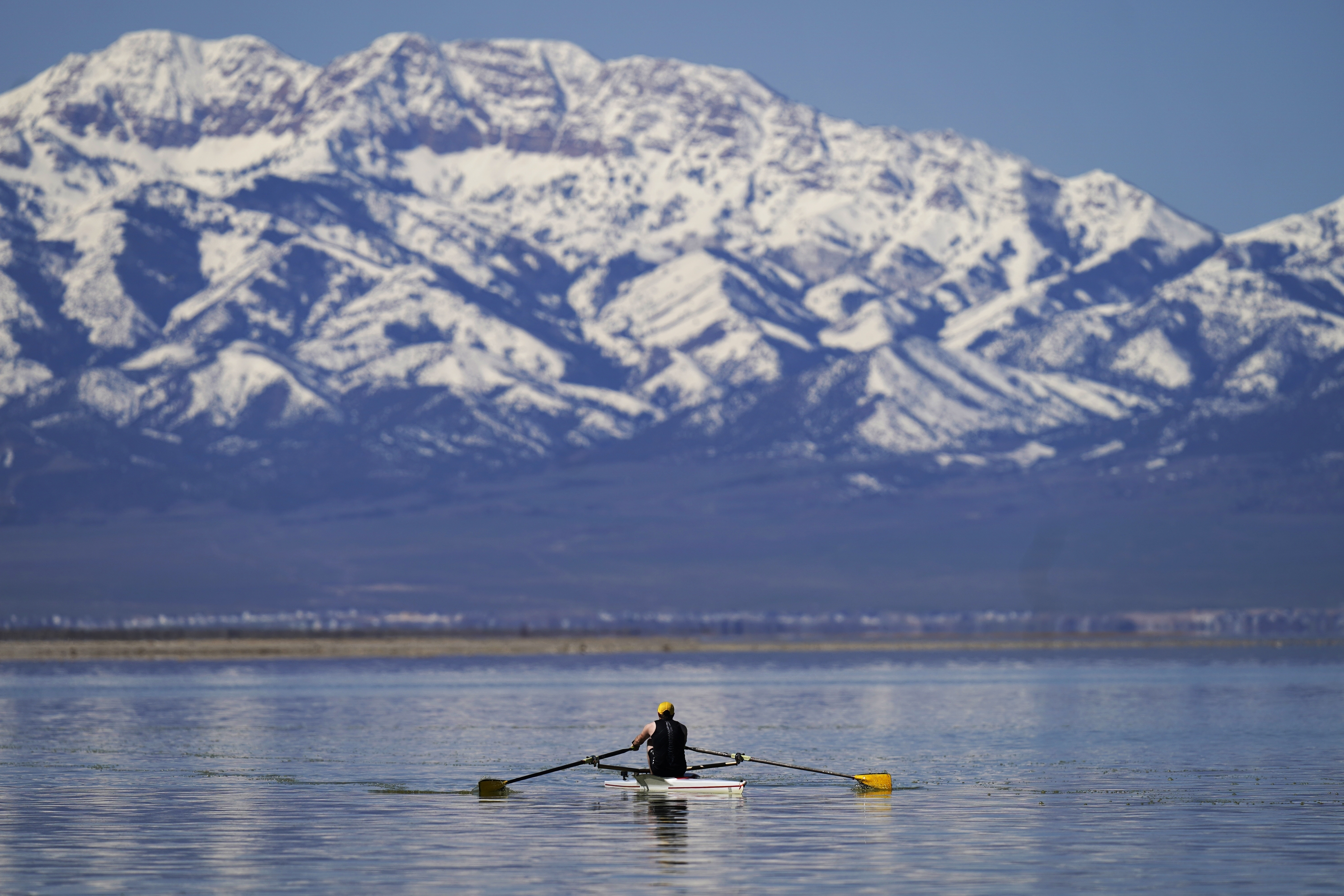 A man rows on the Great Salt Lake on April 15, in Magna. Workers, hobbyists and residents who rely on the Great Salt Lake are rejoicing this year after winter's snow melted and led to a 6-foot rise at the lake.