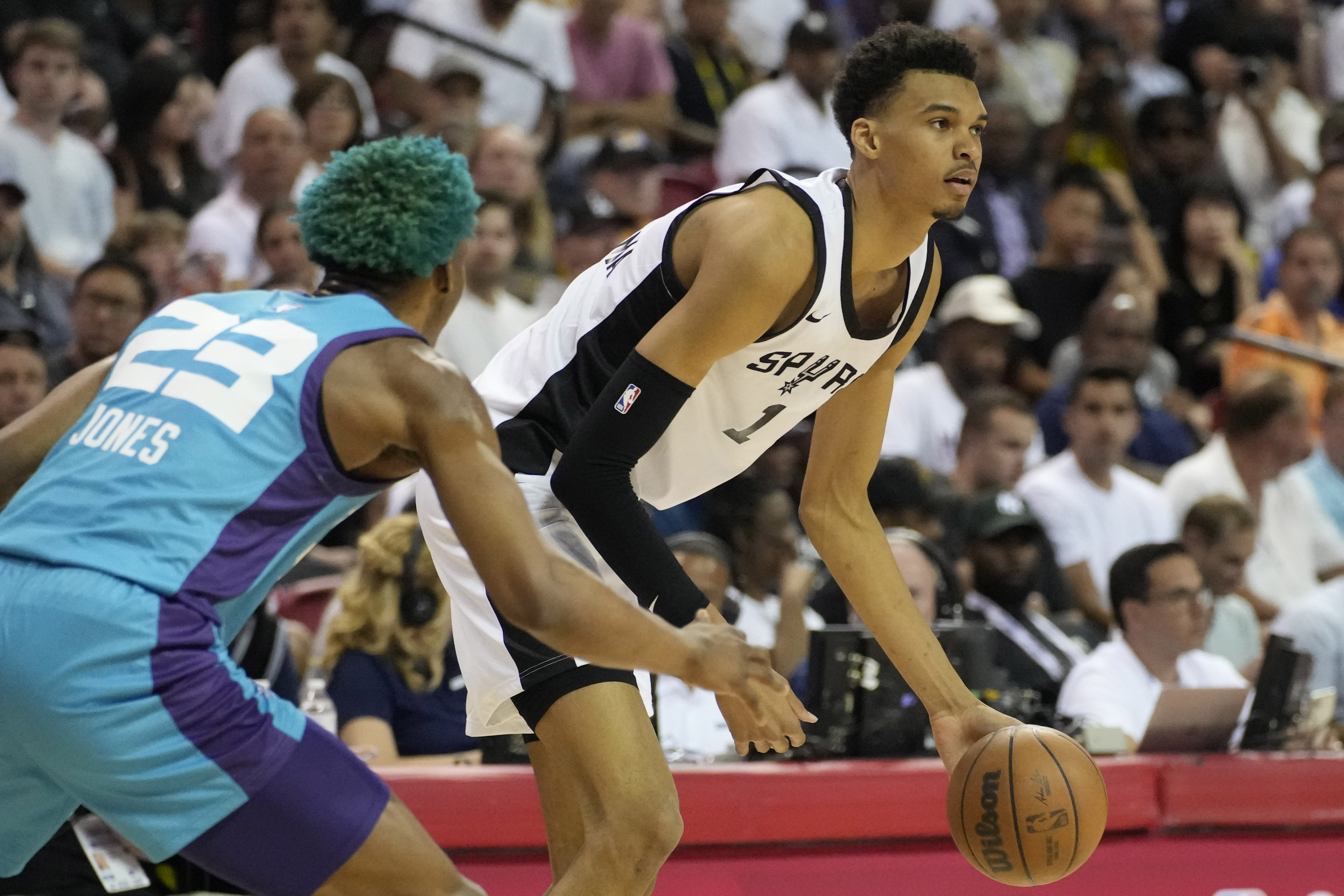 San Antonio Spurs' Victor Wembanyama drives against Charlotte Hornets' Kai Jones during the first half of an NBA summer league basketball game Friday, July 7, 2023, in Las Vegas. 