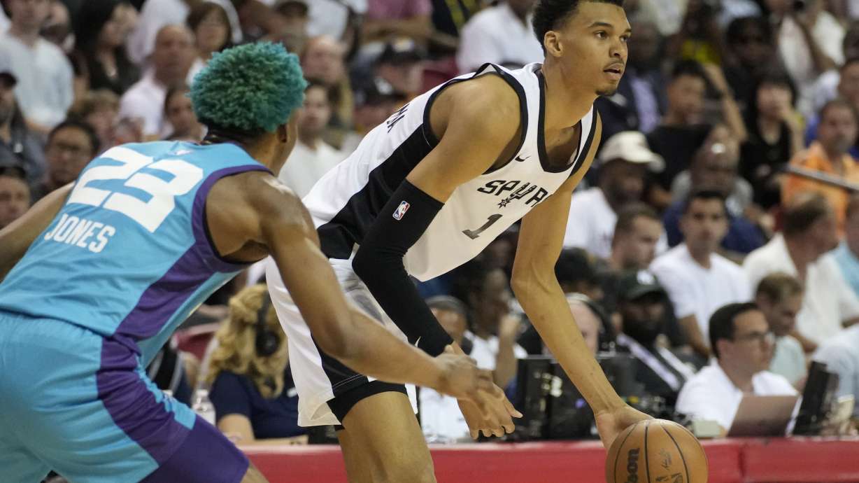 San Antonio Spurs' Victor Wembanyama drives against Charlotte Hornets' Kai Jones during the first half of an NBA summer league basketball game Friday, July 7, 2023, in Las Vegas.