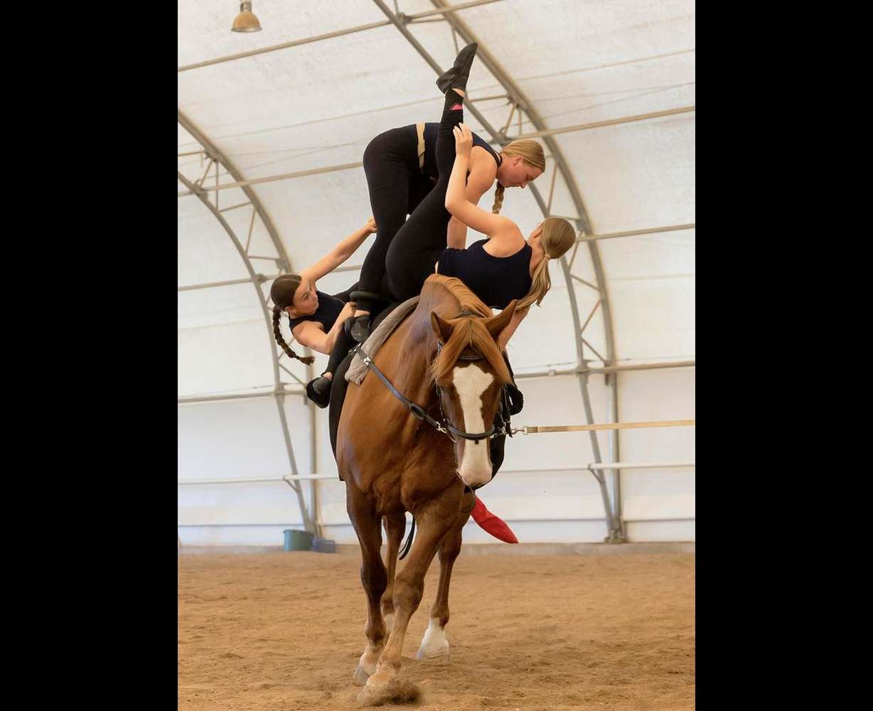 Left to right, Gracie Griffiths, Emma Wilson and Mikell Stoddard practice their routine on horse Cabo San Lucas at Oak Hills Vaulting in Salem on July 7. The team will represent the USA at the FEI Vaulting World Championships for Juniors and Young Vaulters, taking place in Sweden.