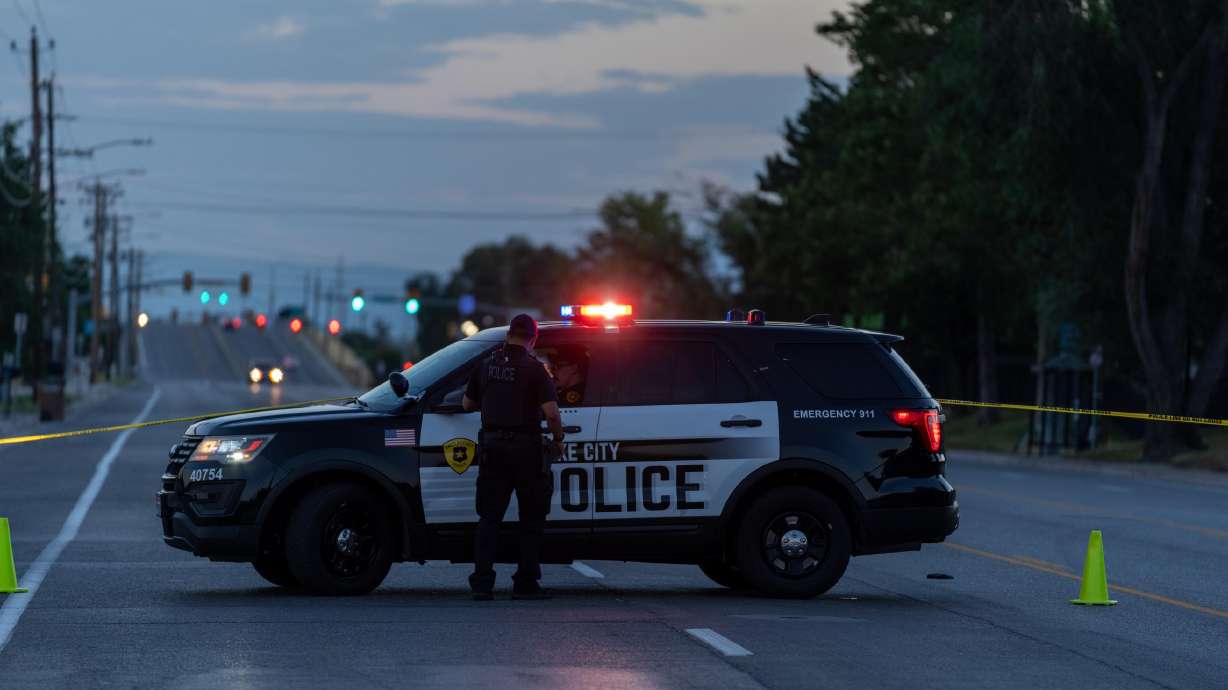 Salt Lake police officers block Redwood Road near 700 South following a fatal hit-and-run crash early Sunday.