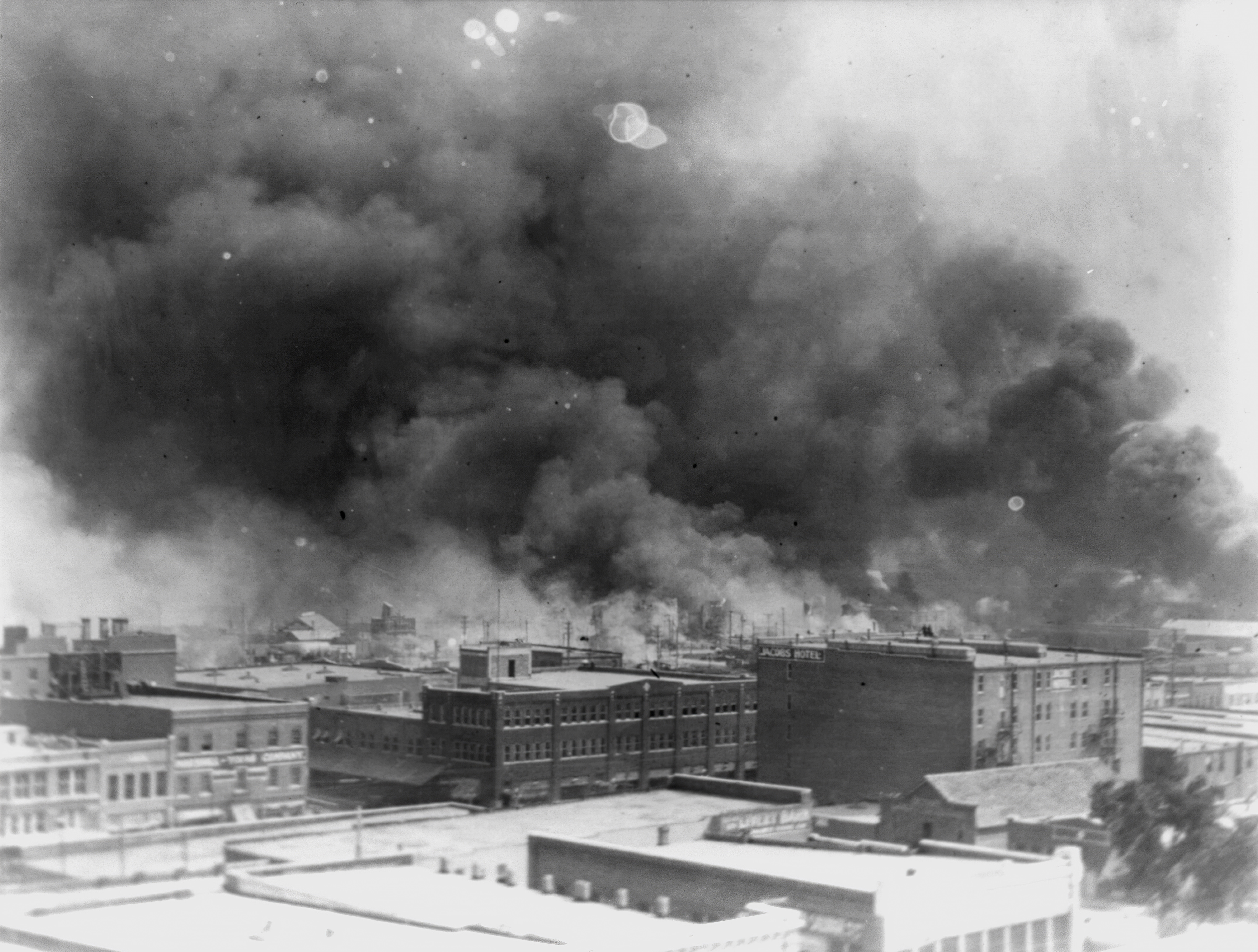In this 1921 image, smoke billows over Tulsa, Okla. An Oklahoma judge has thrown out a lawsuit seeking reparations for the 1921 Tulsa Race Massacre, dashing an effort to obtain a measure of legal justice by survivors of the deadly racist rampage.