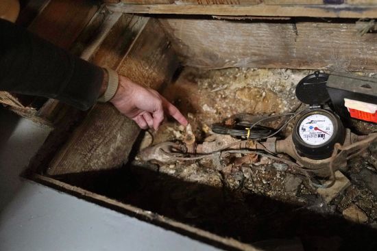 Homeowner Jonathan Crossman points out the existing lead residential water supply line before the Providence Water meter in the basement of his family's home, March 23 in Providence, R.I. Health and environmental groups have been fighting for lead-free water to drink in Providence for at least a decade.