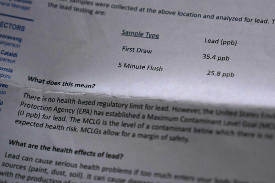High lead levels from a residential water test are shown from a testing report of Providence city water drawn from the pipes in Colleen Colarusso's home March 23 in Providence, R.I. Testing showed lead levels in her water at more than twice the federal limit. Before that, she drank and cooked with tap water.