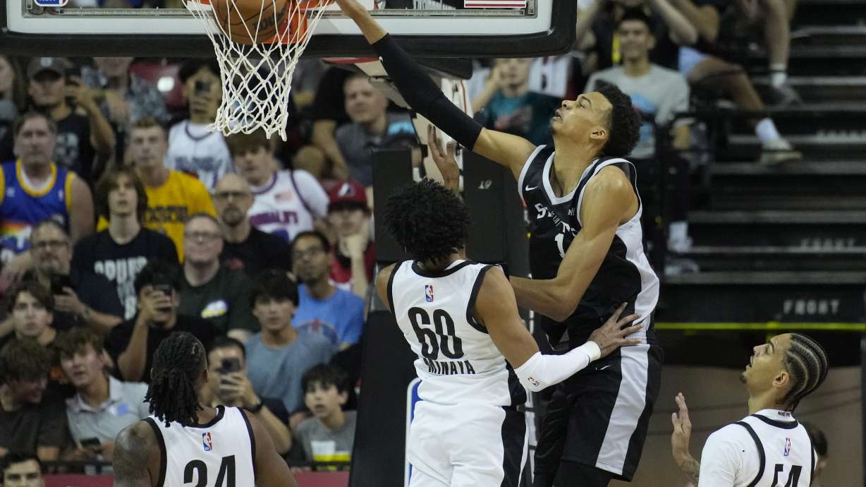 San Antonio Spurs' Victor Wembanyama dunks over Portland Trail Blazers' Justin Minaya during the first half of an NBA summer league basketball game Sunday, July 9, 2023, in Las Vegas.