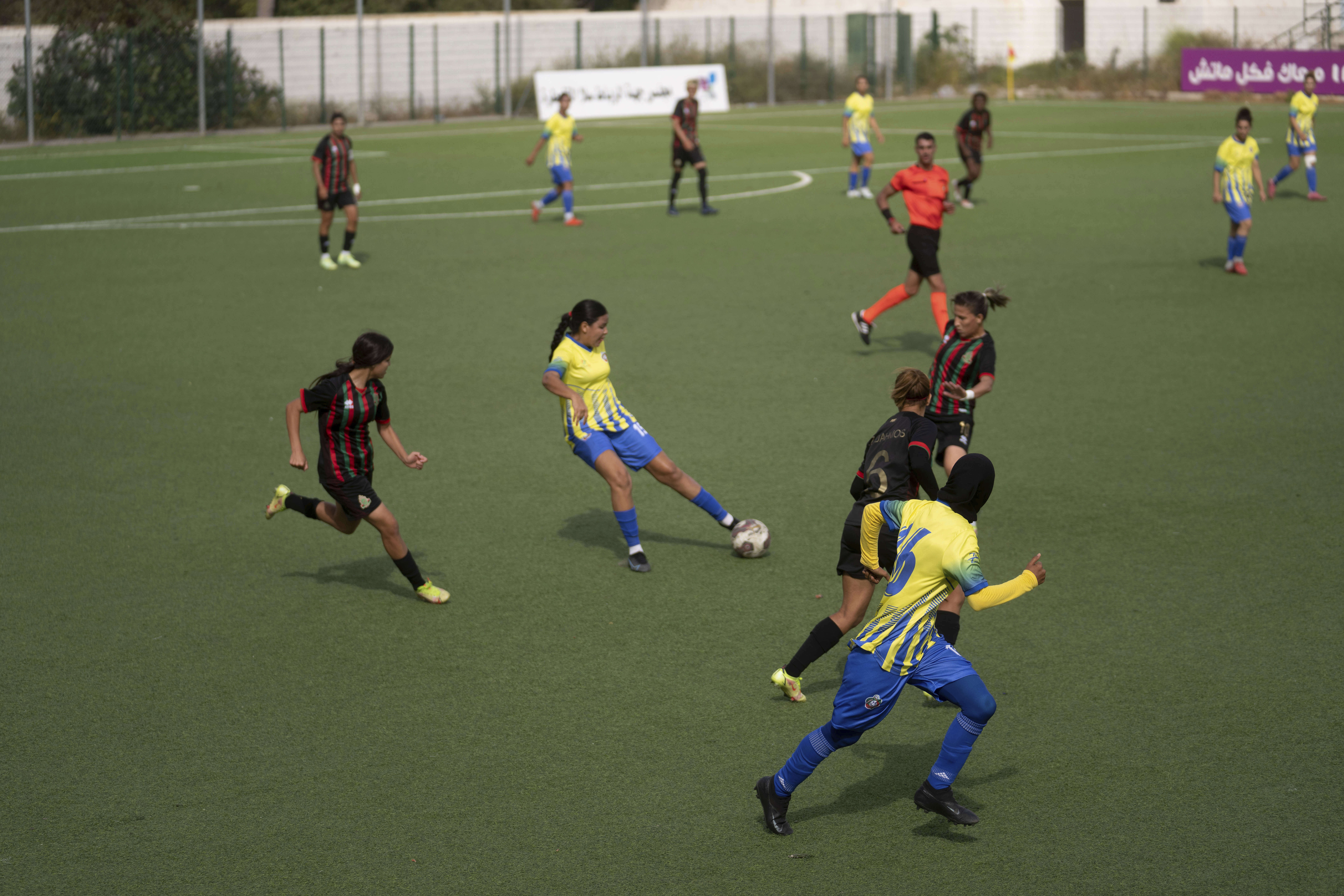 Women footballers compete in a soccer match between ASFAR and ASDCT Ain Atiq, in Morocco's professional women league, in Rabat, Morocco, Wednesday, May 17, 2023. 