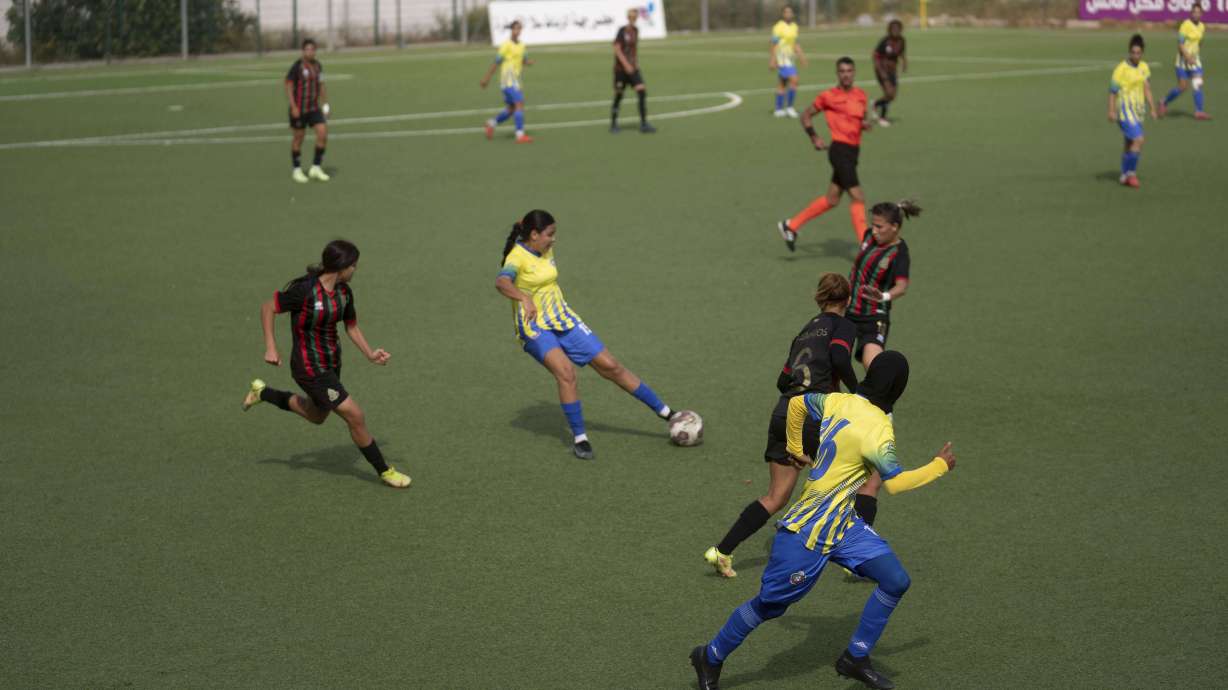 Women footballers compete in a soccer match between ASFAR and ASDCT Ain Atiq, in Morocco's professional women league, in Rabat, Morocco, Wednesday, May 17, 2023.