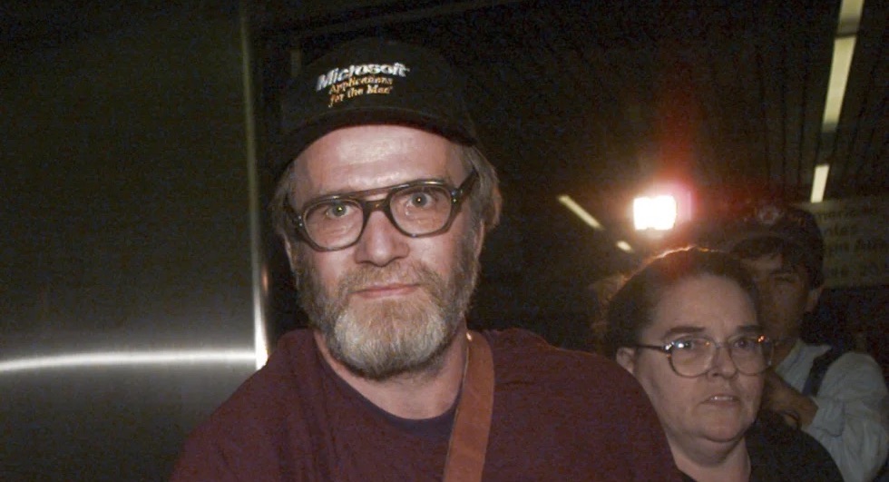 James Lewis is escorted through Boston's Logan Airport, Oct. 13, 1995, after being released from the Federal Correctional Institution in Oklahoma. Lewis, the suspect in the 1982 Tylenol murders, was found dead Sunday.