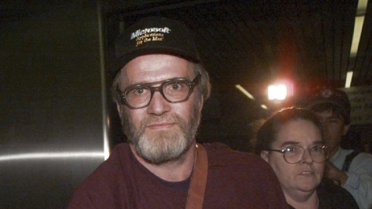 James Lewis is escorted through Boston's Logan Airport, Oct. 13, 1995, after being released from the Federal Correctional Institution in Oklahoma. Lewis, the suspect in the 1982 Tylenol murders, was found dead Sunday.