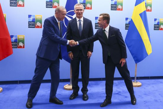 Turkey's President Recep Tayyip Erdogan, left, shakes hands with Sweden's Prime Minister Ulf Kristersson, right, as NATO Secretary General Jens Stoltenberg looks on prior to a meeting ahead of a NATO summit in Vilnius, Lithuania, Monday.