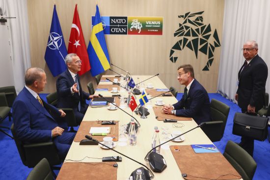 NATO Secretary General Jens Stoltenberg, second left, speaks with Turkey's President Recep Tayyip Erdogan, left, Sweden's Prime Minister Ulf Kristersson, second right, and Turkey's Defense Minister Yasar Guler, right, during a meeting ahead of a NATO summit in Vilnius, Lithuania, Monday.
