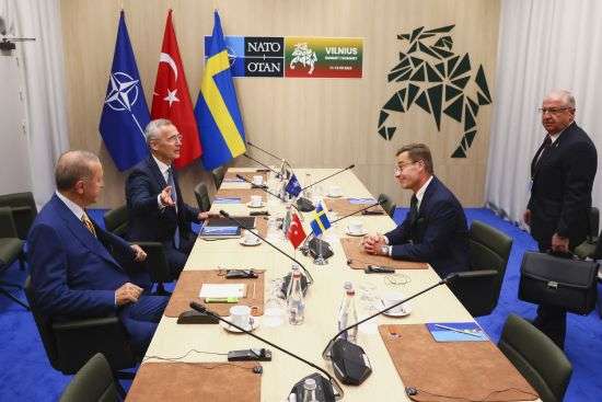 NATO Secretary General Jens Stoltenberg, second left, speaks with Turkey's President Recep Tayyip Erdogan, left, Sweden's Prime Minister Ulf Kristersson, second right, and Turkey's Defense Minister Yasar Guler, right, during a meeting ahead of a NATO summit in Vilnius, Lithuania, Monday.