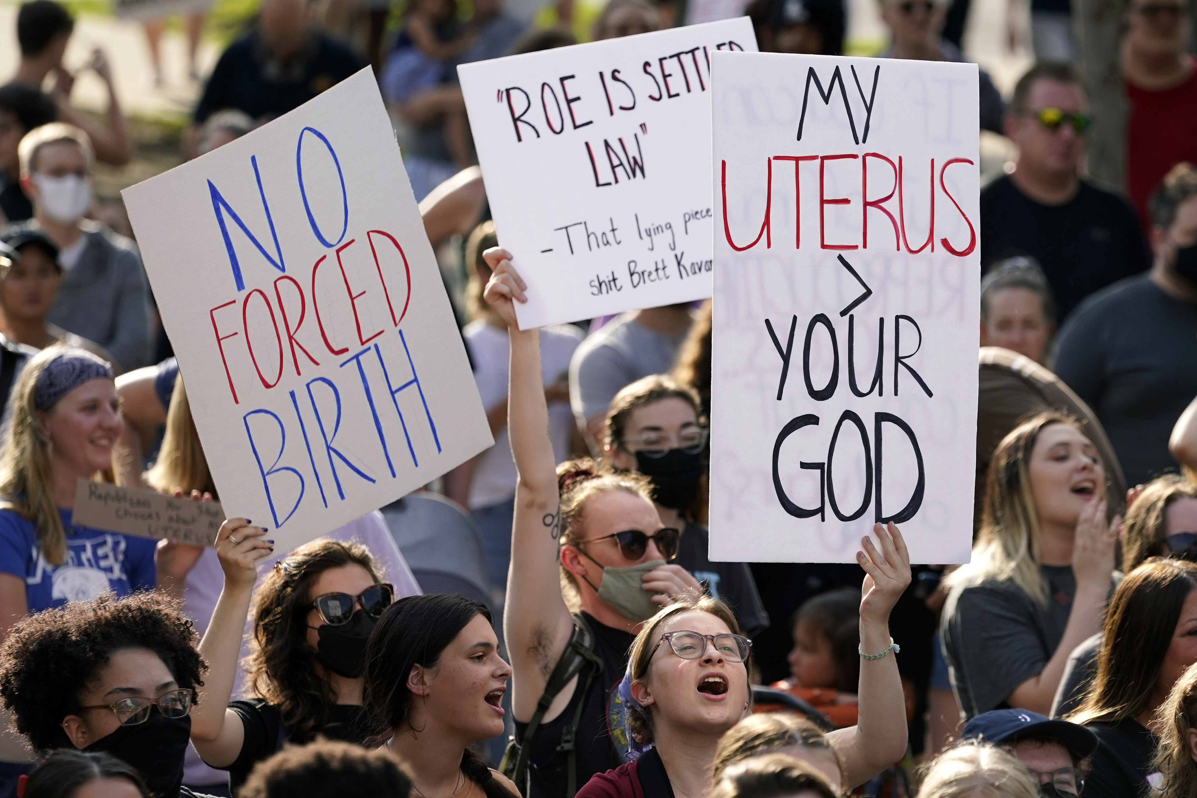 Abortion-rights protesters cheer at a rally, June 24, 2022, in Des Moines, Iowa. Iowa's Republican-led Legislature has passed a bill banning most abortions after roughly six weeks of pregnancy.  Gov. Kim Reynolds immediately said in a statement she would sign the bill on Friday.