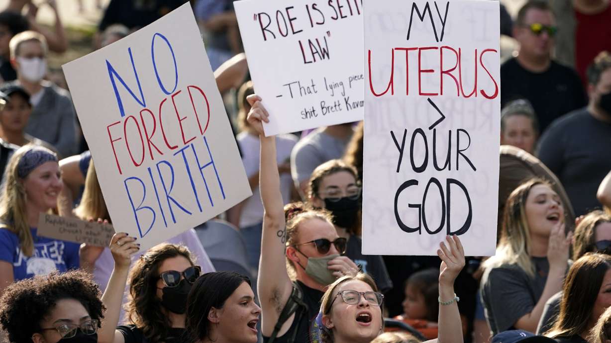 Abortion-rights protesters cheer at a rally, June 24, 2022, in Des Moines, Iowa. Iowa's Republican-led Legislature has passed a bill banning most abortions after roughly six weeks of pregnancy. Gov. Kim Reynolds immediately said in a statement she would sign the bill on Friday.