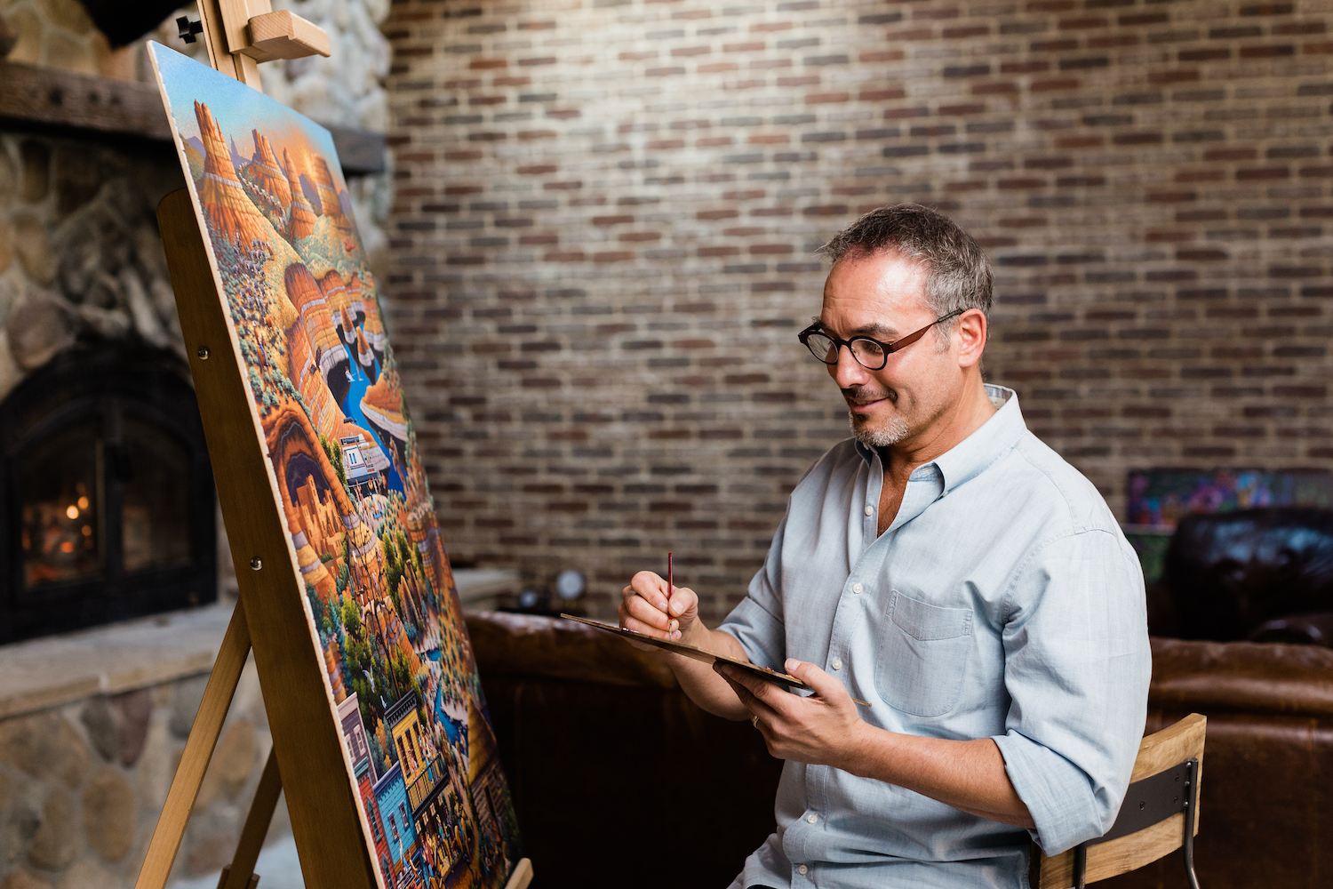 Eric Dowdle paints a scene that will be turned into a puzzle. Dowdle has been painting towns for over 30 years and is painting many Utah towns this year.