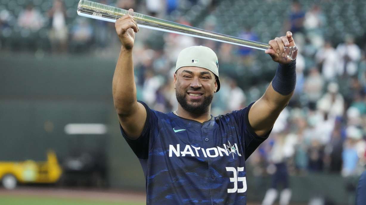 National League's Elias Díaz (35), of the Colorado Rockies, holds up his MVP award after the MLB All-Star baseball game in Seattle, Tuesday, July 11, 2023. The National League won 3-2.