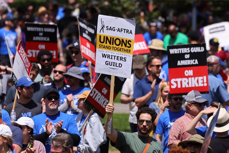 People attend a demonstration held by the Writers Guild of America as the film and TV writers' strike continues, in Los Angeles, June 21. An actors union is on the verge of declaring a strike. 