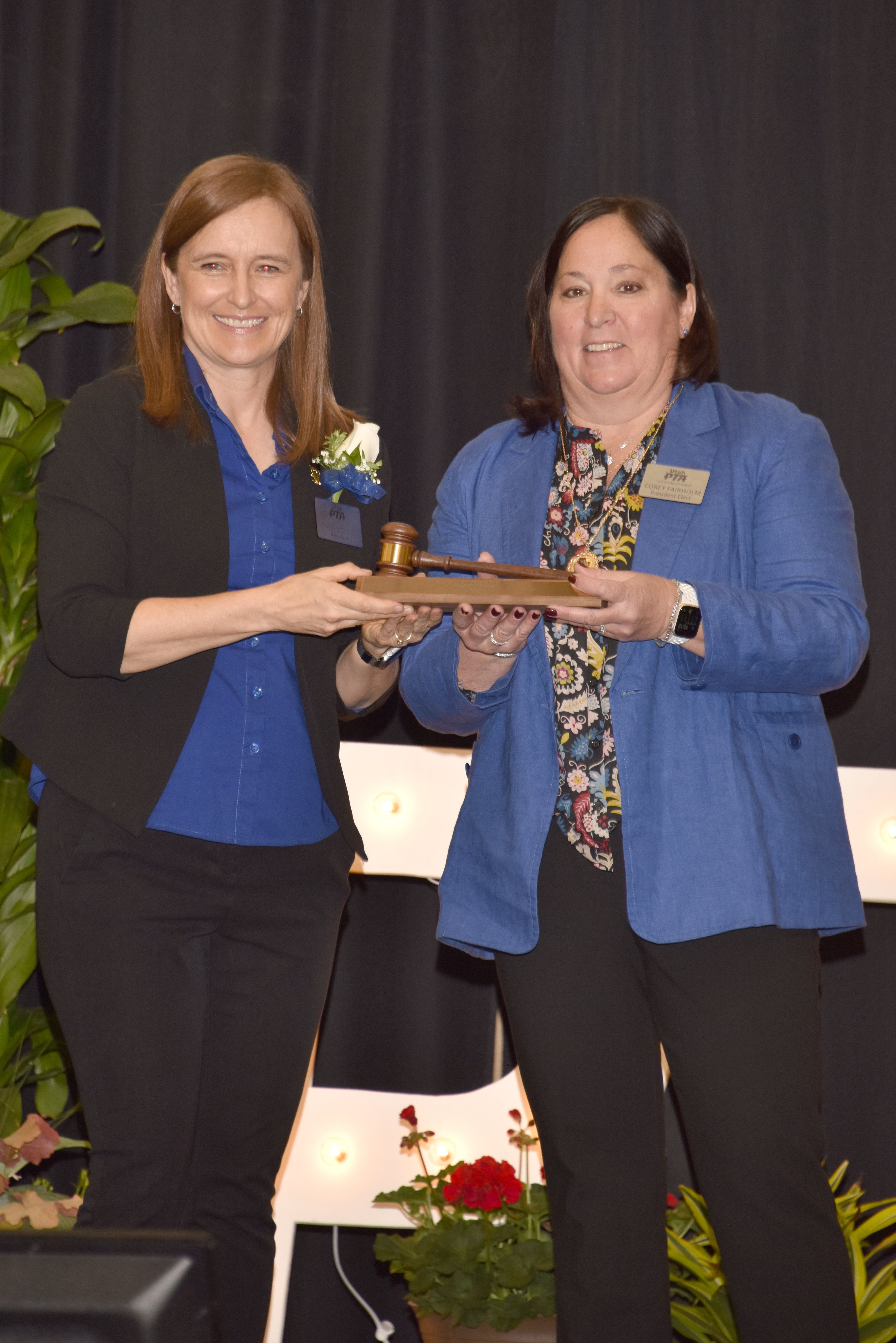 Former Utah PTA president Stacey Mollinet, left, passes the title of PTA president to Corey Fairholm during a Utah PTA Convention. Fairholm took over the role of president for the largest child advocacy group in the state in July.