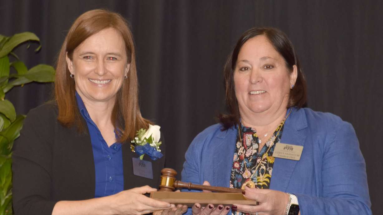 Former Utah PTA president Stacey Mollinet, left, passes the title of PTA president to Corey Fairholm during a Utah PTA Convention. Fairholm took over the role of president for the largest child advocacy group in the state in July.