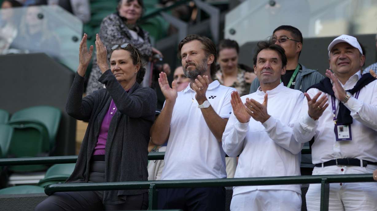 Pam Shriver, left, applauds after Croatia's Donna Vekic defeats Sloane Stephens of the US in the women's singles match on day four of the Wimbledon tennis championships in London, Thursday, July 6, 2023.