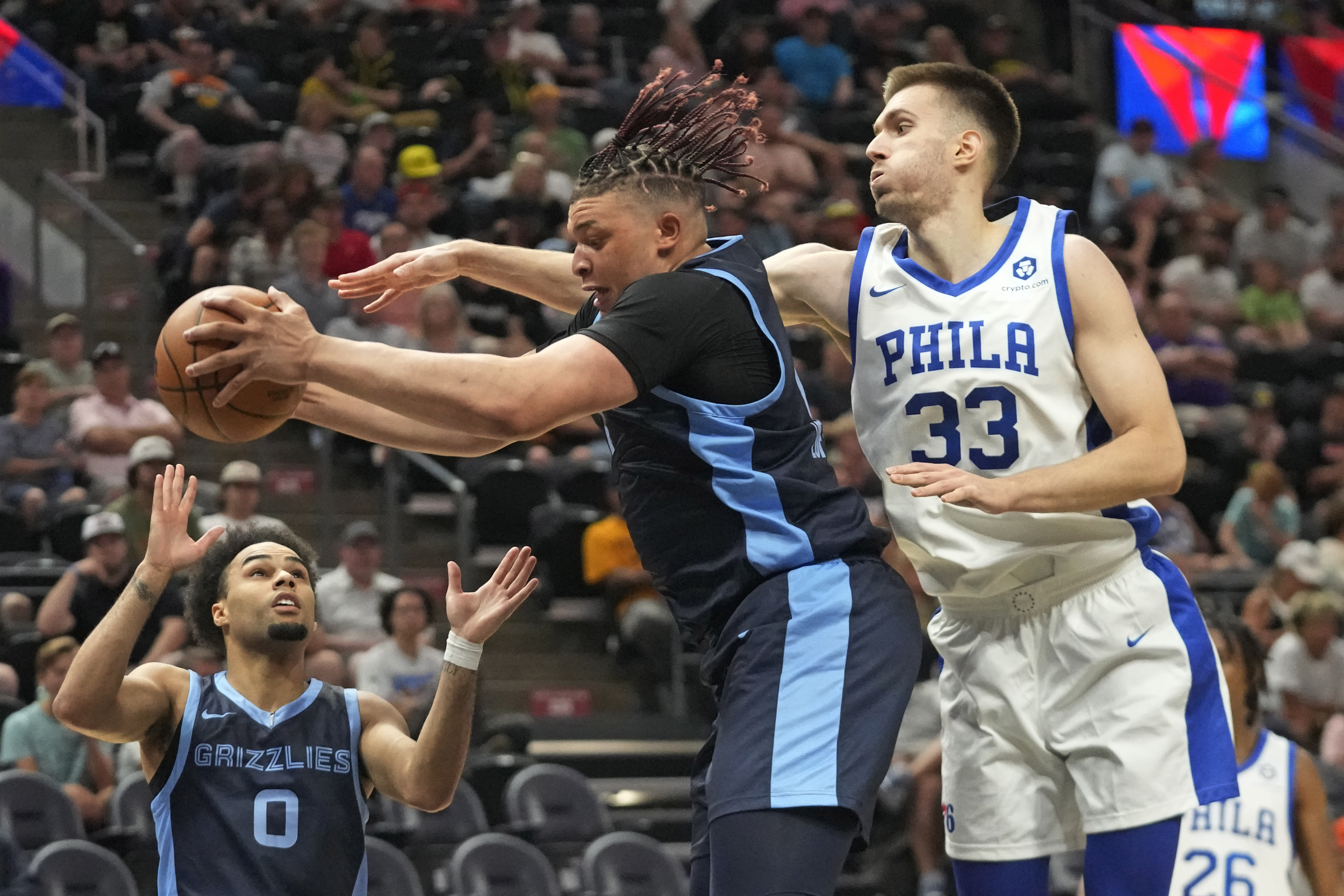Memphis Grizzlies forward Kenneth Lofton Jr., center, pulls down a rebound as Philadelphia 76ers center Filip Petrusev (33) defends in the second half during an NBA Summer League basketball game Monday, July 3, 2023, in Salt Lake City. 