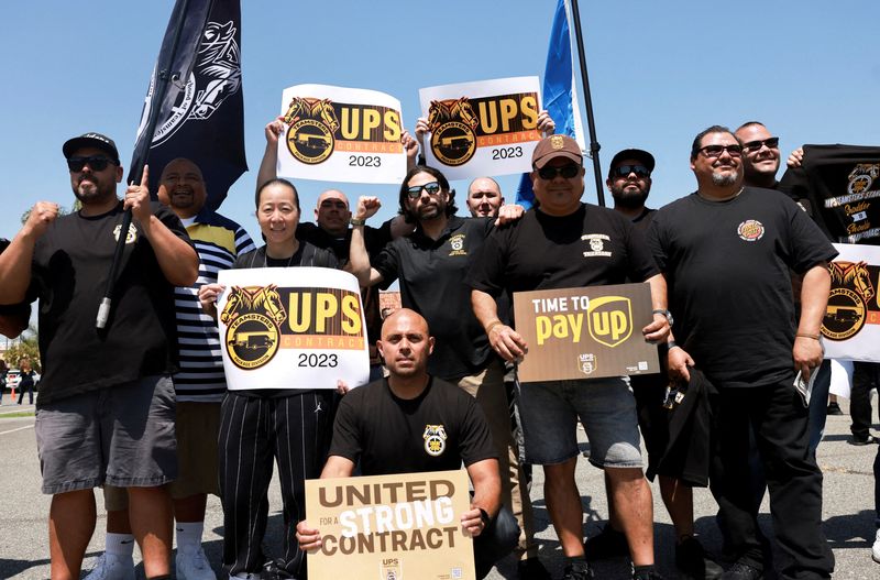 United Parcel Service and the Teamsters hold a rally in Orange, Calif., April 15. A threatened U.S. strike at UPS could be "one of the costliest in at least a century," topping $7 billion for a 10-day work stoppage.