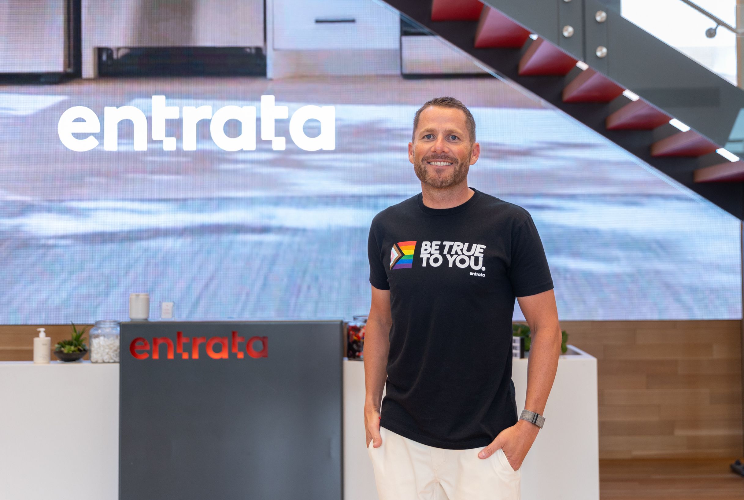 Adam Edmunds, CEO of Entrata, poses for a photo in the lobby of the company’s headquarters in Lehi on Aug. 12, 2022. Entrata announced it has acquired Rent Dynamics.