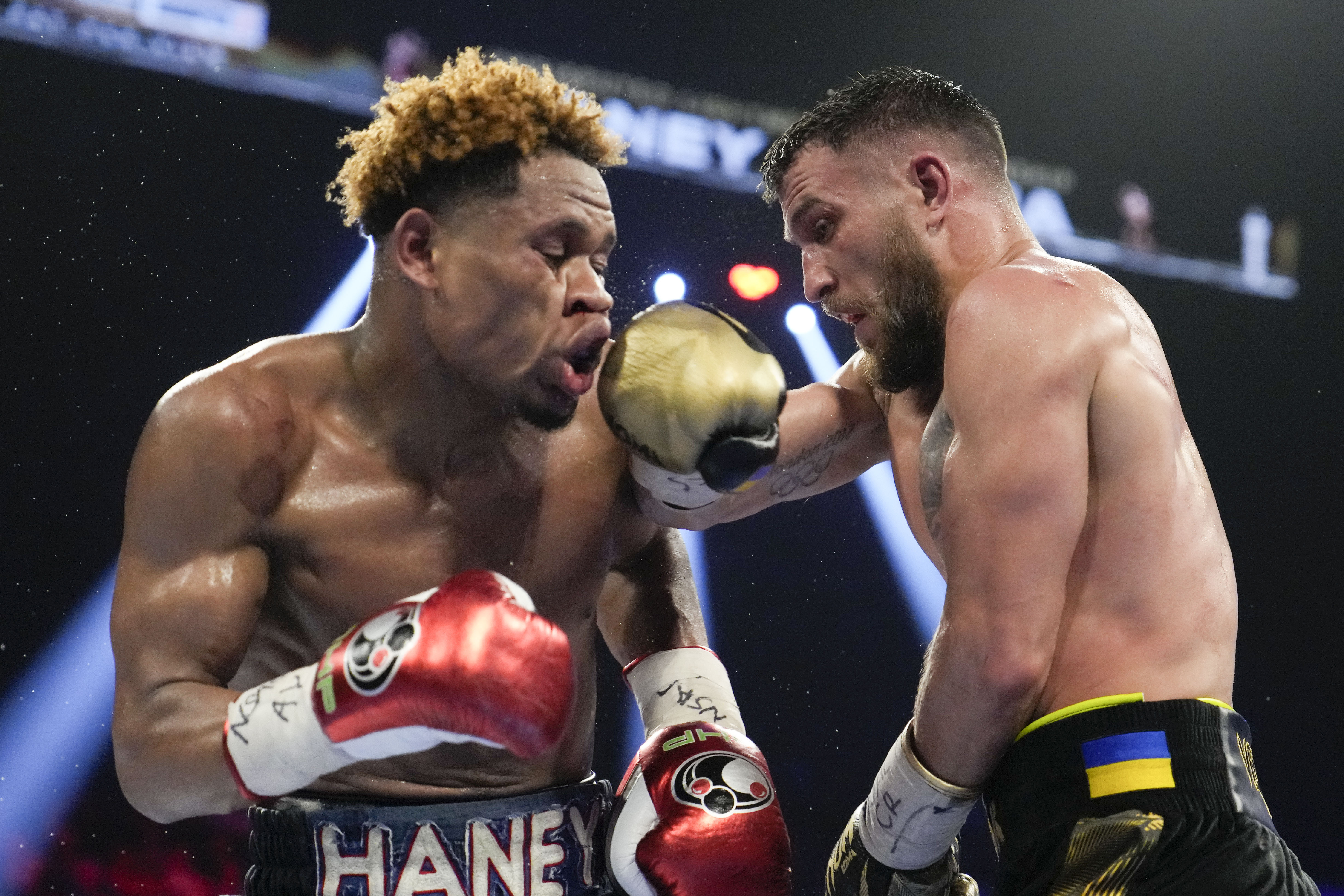 FILE - Devin Haney, left, fights Vasiliy Lomachenko in an undisputed lightweight championship boxing match, May 20, 2023, in Las Vegas. Haney won by unanimous decision. Haney was arrested on a felony weapons charge, Thursday, July 13, in Los Angeles, according to police. 