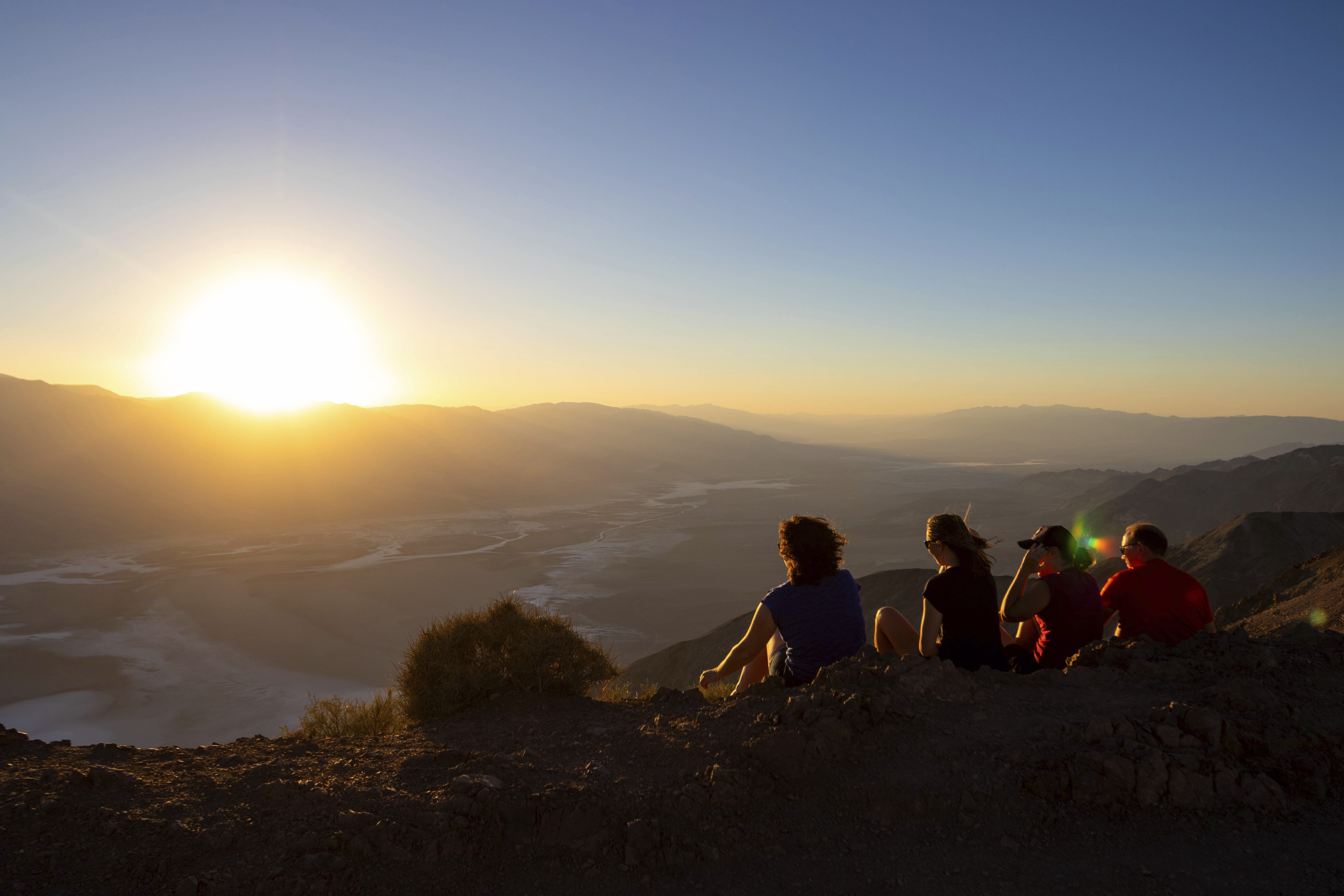 Park visitors watch the sunset on July 11, in Death Valley National Park, Calif. July is the hottest month at the park with an average high of 116 degrees.