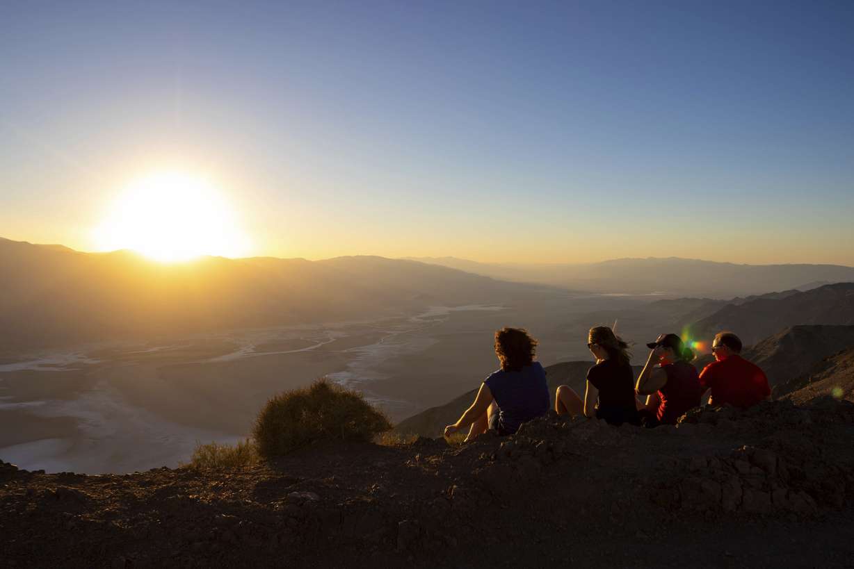 Park visitors watch the sunset on July 11, in Death Valley National Park, Calif. July is the hottest month at the park with an average high of 116 degrees.