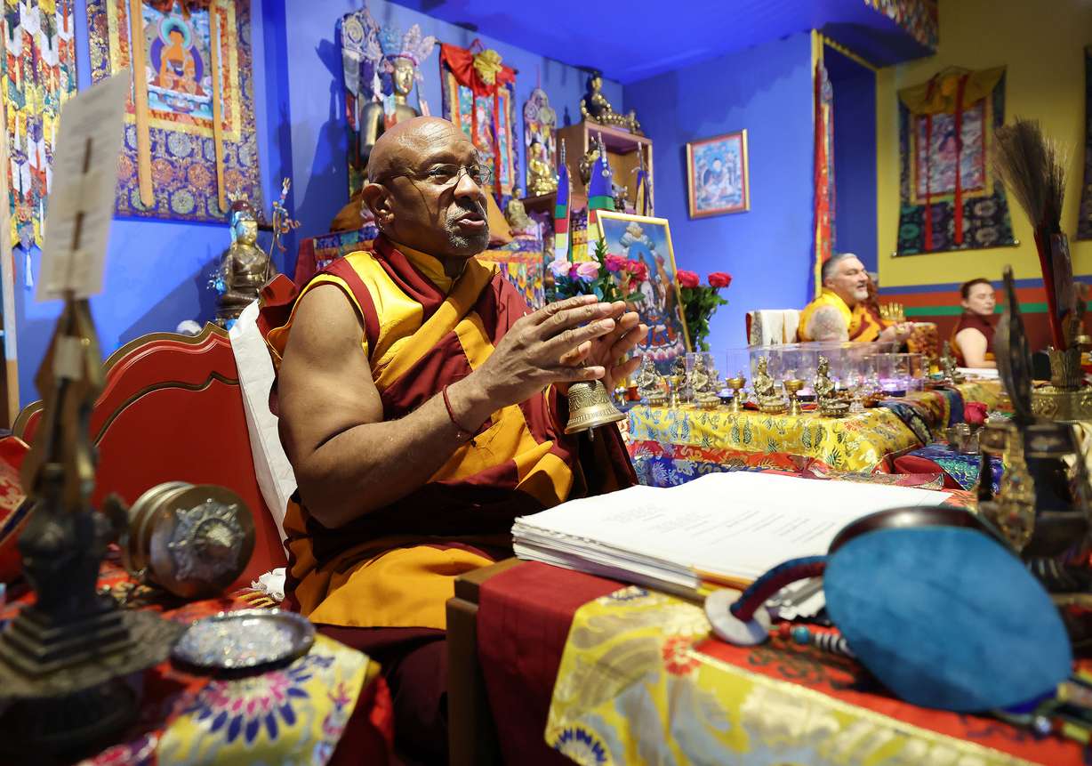 Lama Thupten Gyaltsen Dorje Rinpoche talks with practitioners at the Urgyen Samten Ling Tibetan Buddhist Temple as they participate in Prayers for Compassion in Salt Lake City on Thursday.