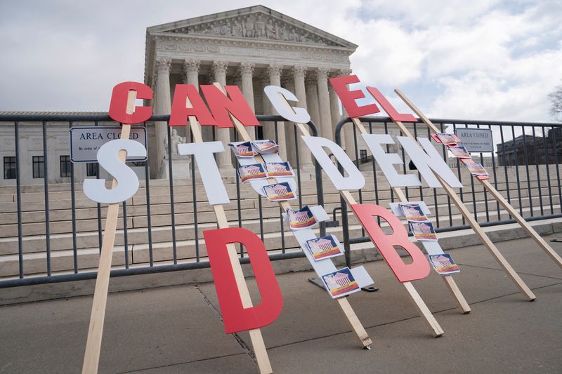 A sign calling for student loan debt relief is seen in front of the Supreme Court as the justices are scheduled to hear oral arguments in two cases involving President Joe Biden's bid to reinstate his plan to cancel billions of dollars in student debt in Washington, Feb. 28. The Biden administration says it will cancel $39 billion in student debt for more than 804,000 borrowers.