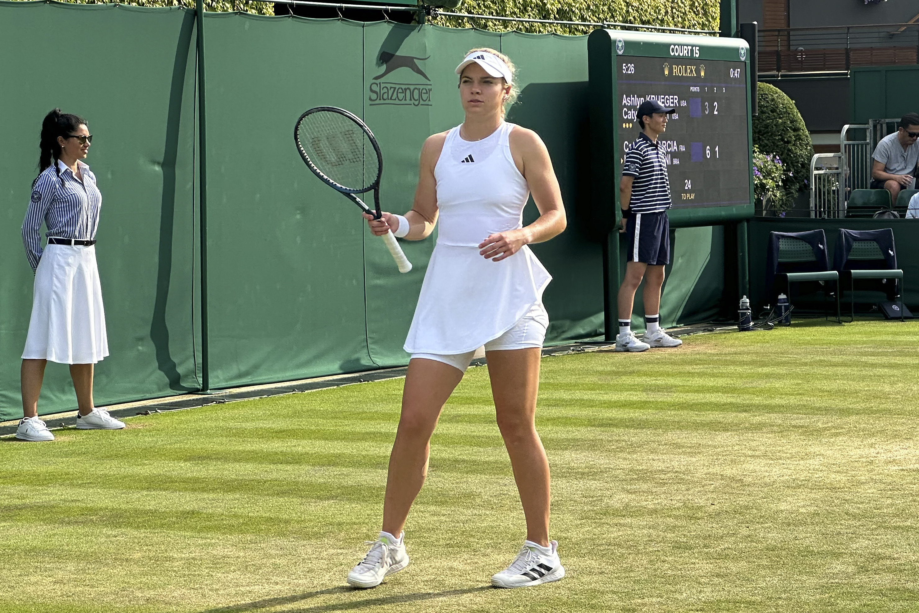Caty McNally stands on court as her and playing partner Ashlyn Krueger, not in photo, of the United States play against Caroline Garcia of France and Luisa Stefani of Brazil in a first-round women's doubles match at Wimbledon on July 8, 2023. McNally, a 21-year-old tennis player from Ohio, was one of six of 128 entrants in women's singles at Wimbledon who has a female coach, about 5%. The women's professional tennis tour hopes to increase the number of women coaching at the sport's top level and has started a program to help aspiring coaches get there.