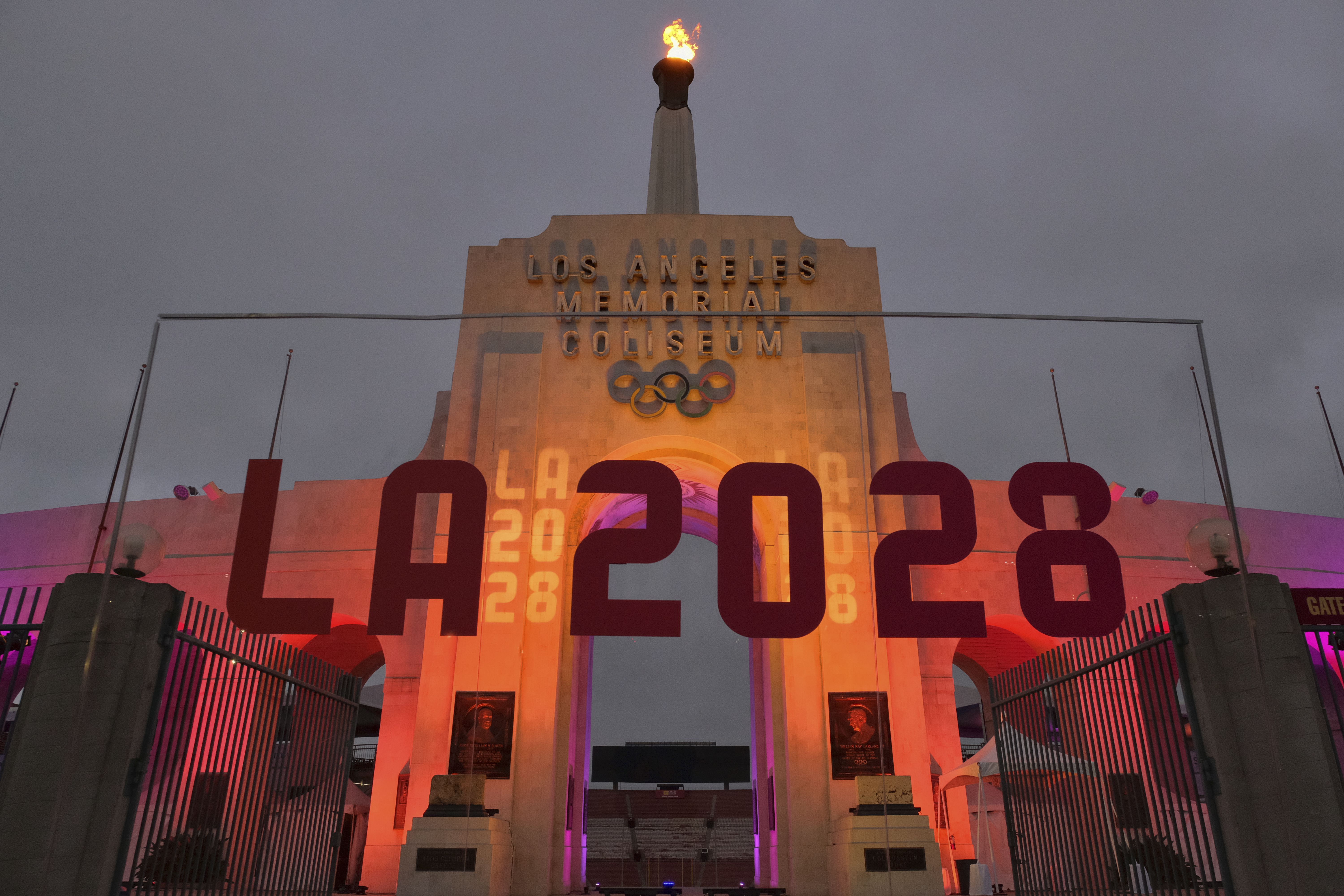 An LA2028 sign is seen in front of a blazing Olympic cauldron at the Los Angeles Memorial Coliseum on Wednesday, Sept. 13, 2017. The cauldron was lit early Wednesday morning at the stadium that was the site of the 1932 and 1984 Olympics.
