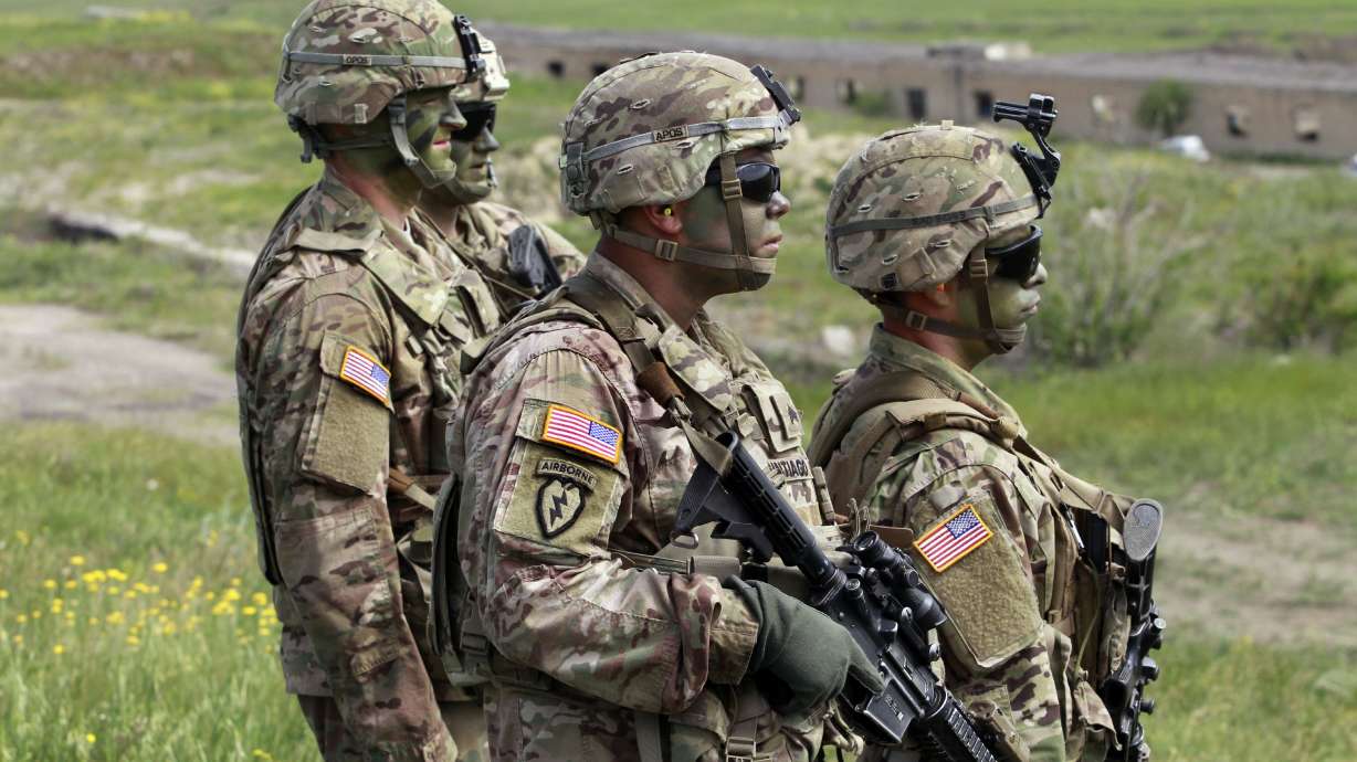 U.S. servicemen march to firing positions during joint military exercises at the Vaziani military base outside Tbilisi, Georgia, in 2016. President Joe Biden authorized the deployment of 3,000 reserve forces to Europe on Thursday.