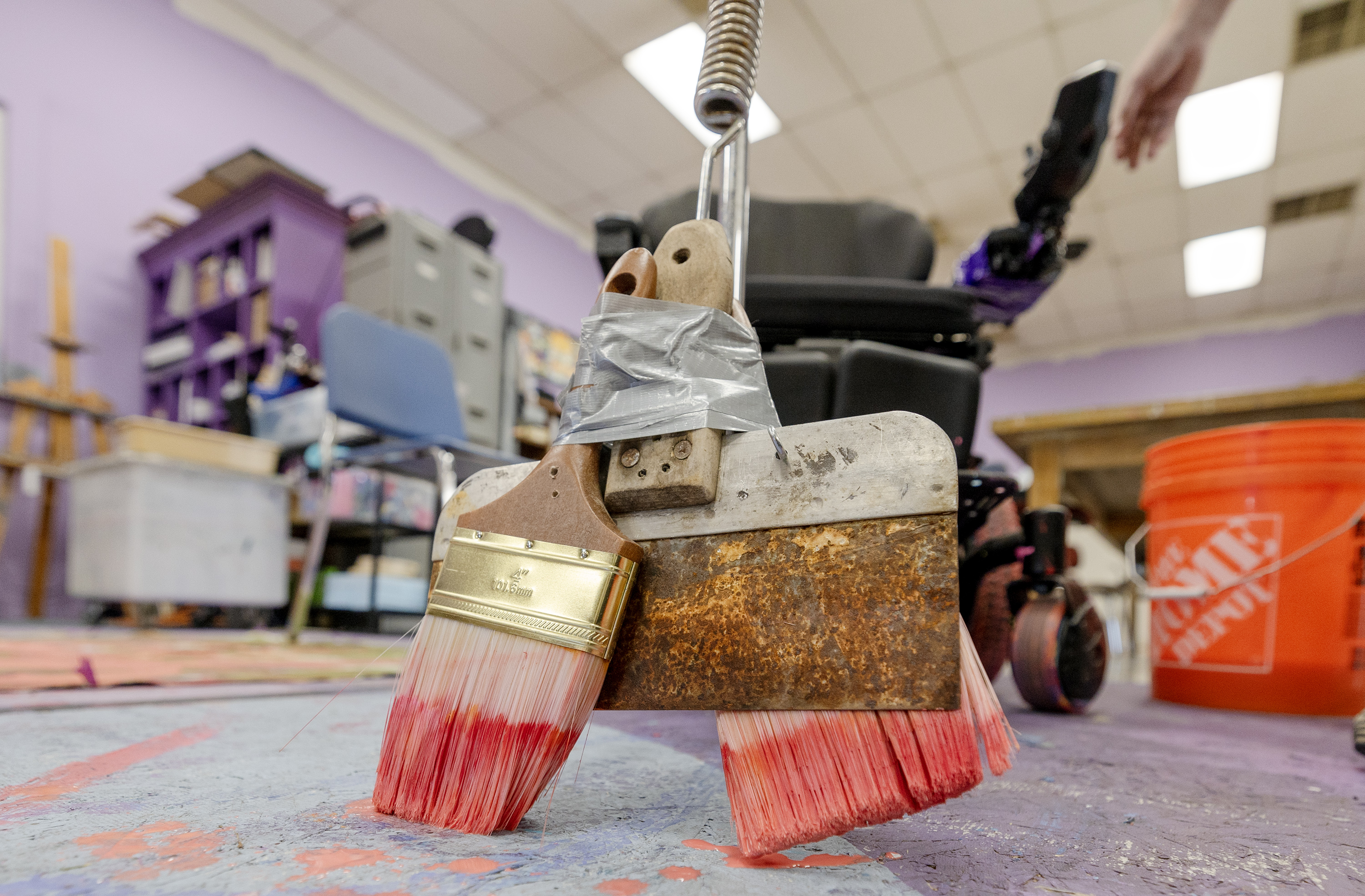 Michael Bingham, executive director of Jump the Moon, a nonprofit art studio and gallery organization in Logan, shows a specially outfitted wheelchair that Kaya Eccles, an artist, uses as she paints on Wednesday.