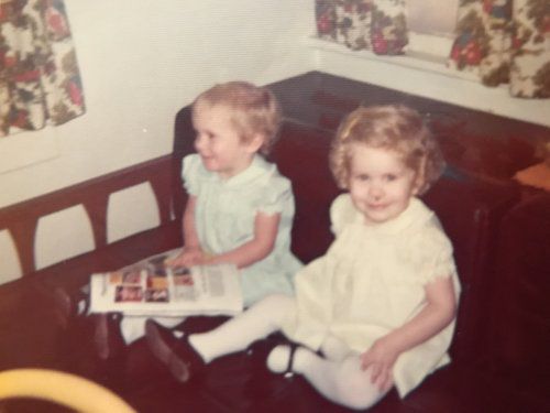 Twin sisters Tasha, left, and Tonya Cram, right, sit for picture book time.